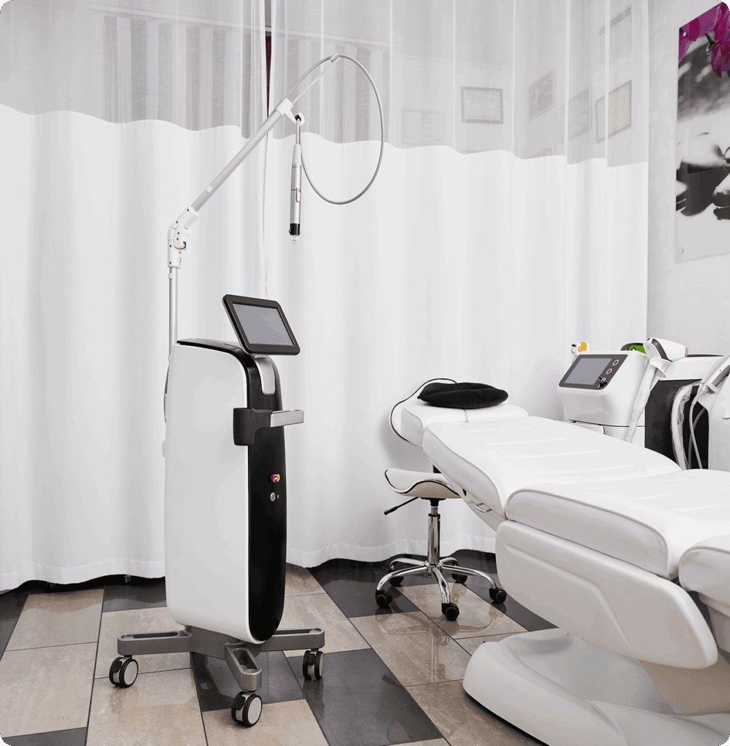 Medical treatment room with equipment and bed.