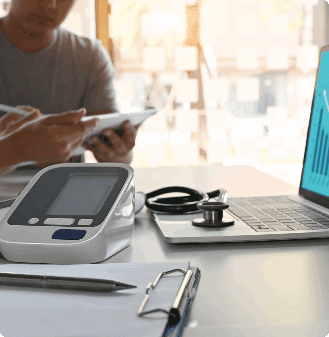 Medical equipment and laptop on office desk.